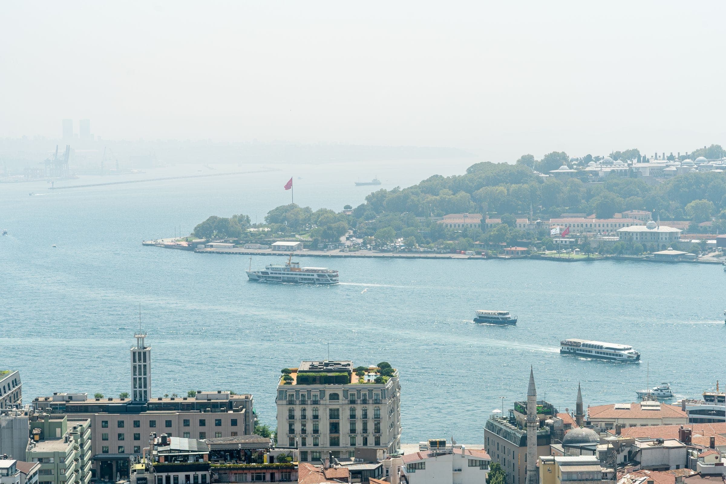 Hazy aerial view of the Bosphorus in Istanbul with ferries and the historic peninsula