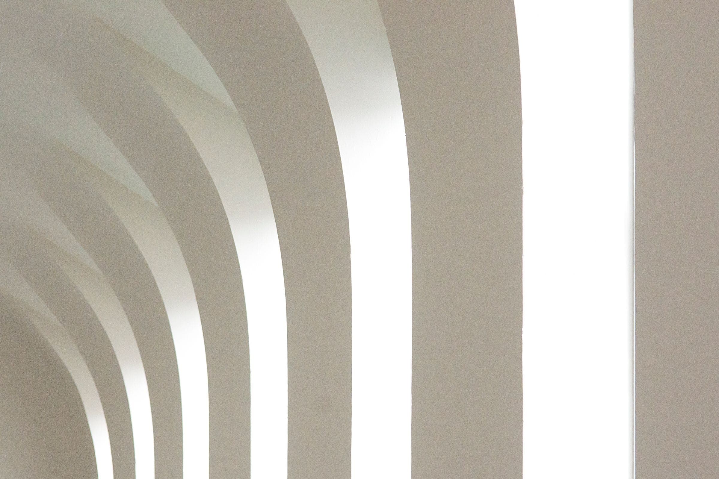 Repeating white arches in soft daylight